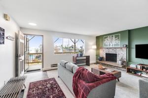 a living room with a couch and a fireplace at Cozy Hilltop Seattle Stay with Yard & Parking in Seattle