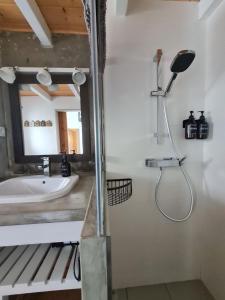 a bathroom with a sink and a shower at Alba Odeceixe - casa aurea in Odeceixe +41 photos