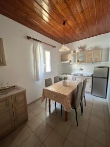 a kitchen with a table and chairs and a kitchen with a table and a kitchen at Poseidon Beach Bar & Restaurant Apartments in Paleokastritsa