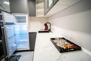 a kitchen with an open refrigerator and a table at LaRin Residence in Bucharest +44 photos