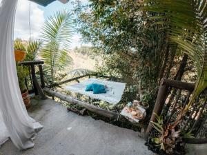 a bed in a garden next to a fence at hotel boutique Almaia 17 cerca del aeropuerto jose m cordova in Rionegro