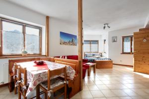 a living room with a table and a couch at Dolomiti Comfortspace Free Parking in San Niccolò Comèlico +43 photos