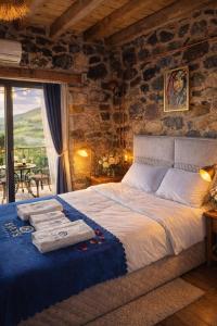 a bedroom with a bed with towels on it at FİNTOZ BUTİKA New in Karaburun
