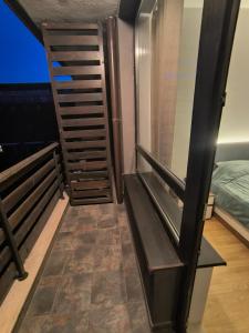 a room with a staircase next to a bed at Sasha Yo in Razlog +3 photos