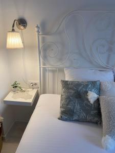 a bed with a blue headboard and a pillow at Vikendica Fruška lipa in Čortanovci