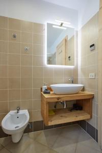 a bathroom with a sink and a mirror at Dolomiti Comfortspace Free Parking in San Niccolò Comèlico