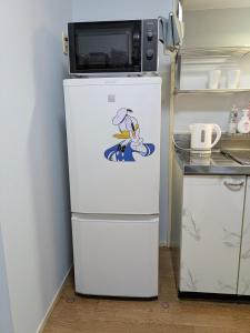 a white refrigerator with a microwave on top of it at エルビスコート井尻101号 in Morooka +19 photos
