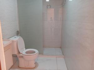 a bathroom with a pink toilet and a shower at Star Gate Camp in Wadi Rum