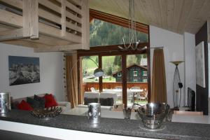 a kitchen with a large window and a living room at Edelweiss B31 in Morgins