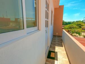 a balcony with a door and a window on a building at Depa Altavela en Bahía, Hospital IMSS 33 muy cerca in Mezcales