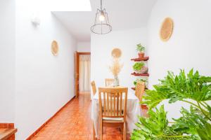 a dining room with a table and chairs and plants at Casa Petra - Traditional Canary House in Güimar +15 photos