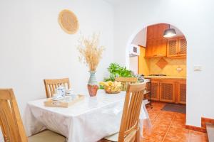 a kitchen with a table with a white table cloth on it at Casa Petra - Traditional Canary House in Güimar
