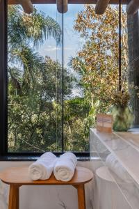 a room with a window with towels on a table at Pousada Parador 33 in Biguaçu +99 photos