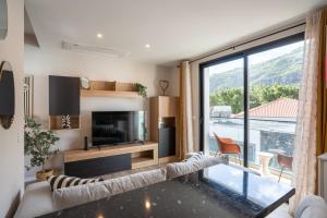a living room with a couch and a large window at Golden Tide in Machico
