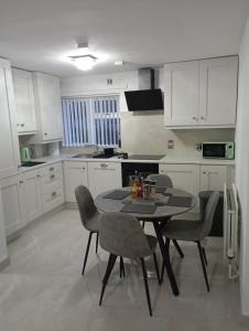 a kitchen with a table and chairs in it at the foyle bridge apartment in Derry Londonderry