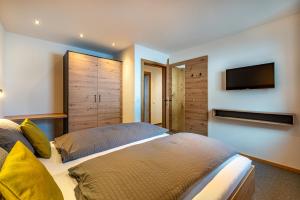 a bedroom with two beds and a flat screen tv at Ferienhaus Leo in See