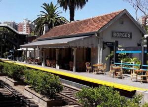 a train station with tables and chairs on a platform at Olivos Stay in Olivos +25 photos