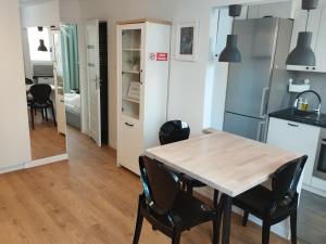 a kitchen and dining room with a table and chairs at Na Sadowej in Grodzisk Mazowiecki +11 photos