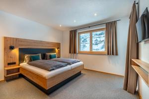 a bedroom with a bed and a window at Ferienhaus Leo in See