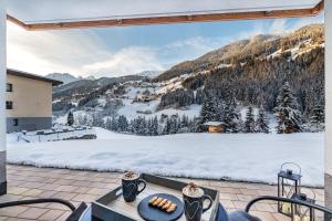 a patio with a view of a snow covered mountain at Ferienhaus Leo in See