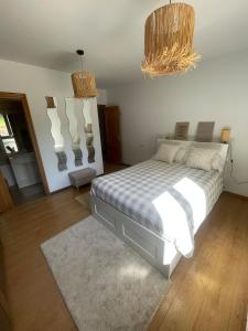 a bedroom with a bed and two chandeliers at Casa Socias in Camoca
