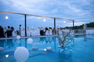 a wedding ceremony in the pool at a wedding at Lalloudes Hotel Mani in Éxo Nímfion +236 photos