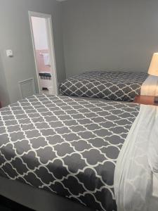 a bedroom with a bed with a black and white comforter at Southland Motor Lodge Hotel in Woodhaven
