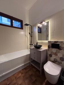 a bathroom with a toilet and a sink and a tub at Conacul Fluturilor in Sinaia +26 photos