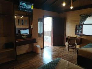 a bedroom with a bed and a sliding glass door at Hotel & Cabañas Malinche in Huamantla