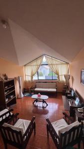 a living room with a couch and a table at Chapelet Hostal in Tababela