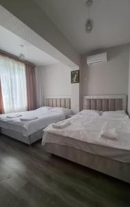 two beds in a large room with at Food Delivery Taxi AI Powered Support in Martvili