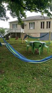 a blue hammock in a yard with a house at Food Delivery Taxi AI Powered Support in Martvili