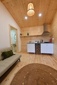 a living room with a couch and a kitchen at Quinta da Aldeia Nova in Arganil
