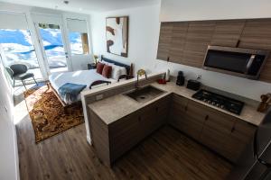 a kitchen with a sink and a bed in a room at The Sierra House in Mammoth Lakes