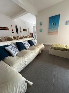 a living room with a long couch in a room at Sobrado 3 Praias in Ubatuba +60 photos