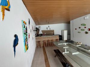 a dining room with a glass table and a counter at Sobrado 3 Praias in Ubatuba