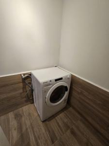 a washing machine sitting in the corner of a room at Poolside Apartment Barcelona Sant Cugat in Sant Cugat del Vallès