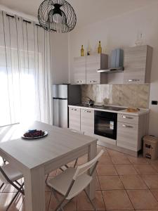 a kitchen with a table and two chairs and a table and a table at La Piuma in Misterbianco