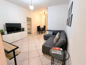 a living room with a couch and a tv at Casa André Imola in Imola