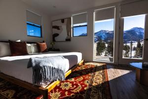 a bedroom with a bed with a mountain view at The Sierra House in Mammoth Lakes