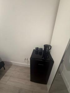 a black coffee maker in a corner of a room at Balham in London