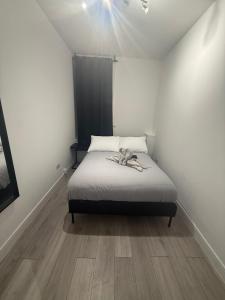 a bedroom with a bed with a bow on it at Balham in London