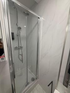 a shower with a glass door in a bathroom at Balham in London