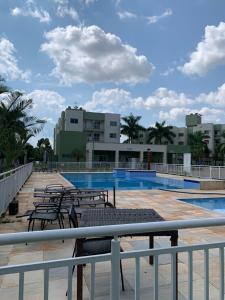 a view of a pool with tables and chairs at Apartamento vita bella in Porto Velho