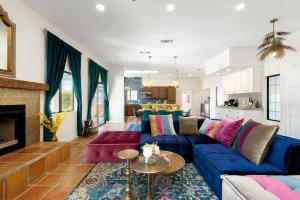 a living room with a blue couch and a fireplace at Moroccan Desert Oasis -Salt Pool - Spa - Games in Bermuda Dunes