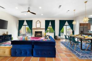 a living room with a blue couch and a table at Moroccan Desert Oasis -Salt Pool - Spa - Games in Bermuda Dunes