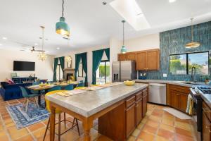 a kitchen with a large island in the middle at Moroccan Desert Oasis -Salt Pool - Spa - Games in Bermuda Dunes