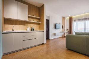 a kitchen with a sink and a couch in a room at Apartments Kan in Ulcinj