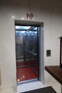 an elevator with a glass door in a building at Hotel Aris in Sofia