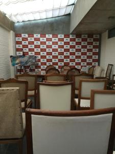 a room full of chairs and tables with a wall of boxes at Hotel Posada La Comandancia in Melo +45 photos